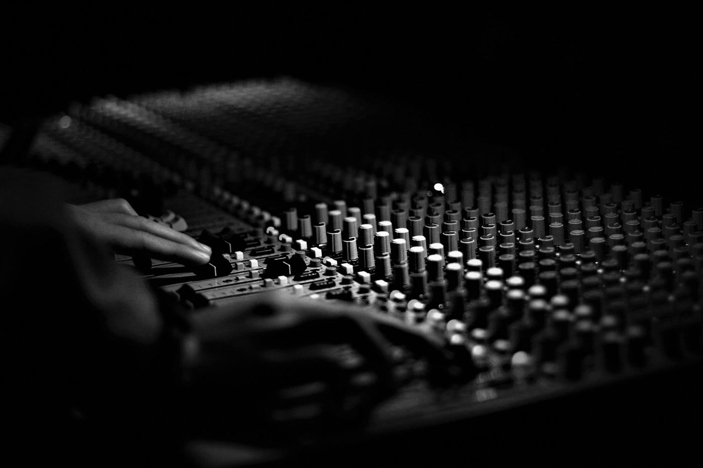 Hands on a mixing console