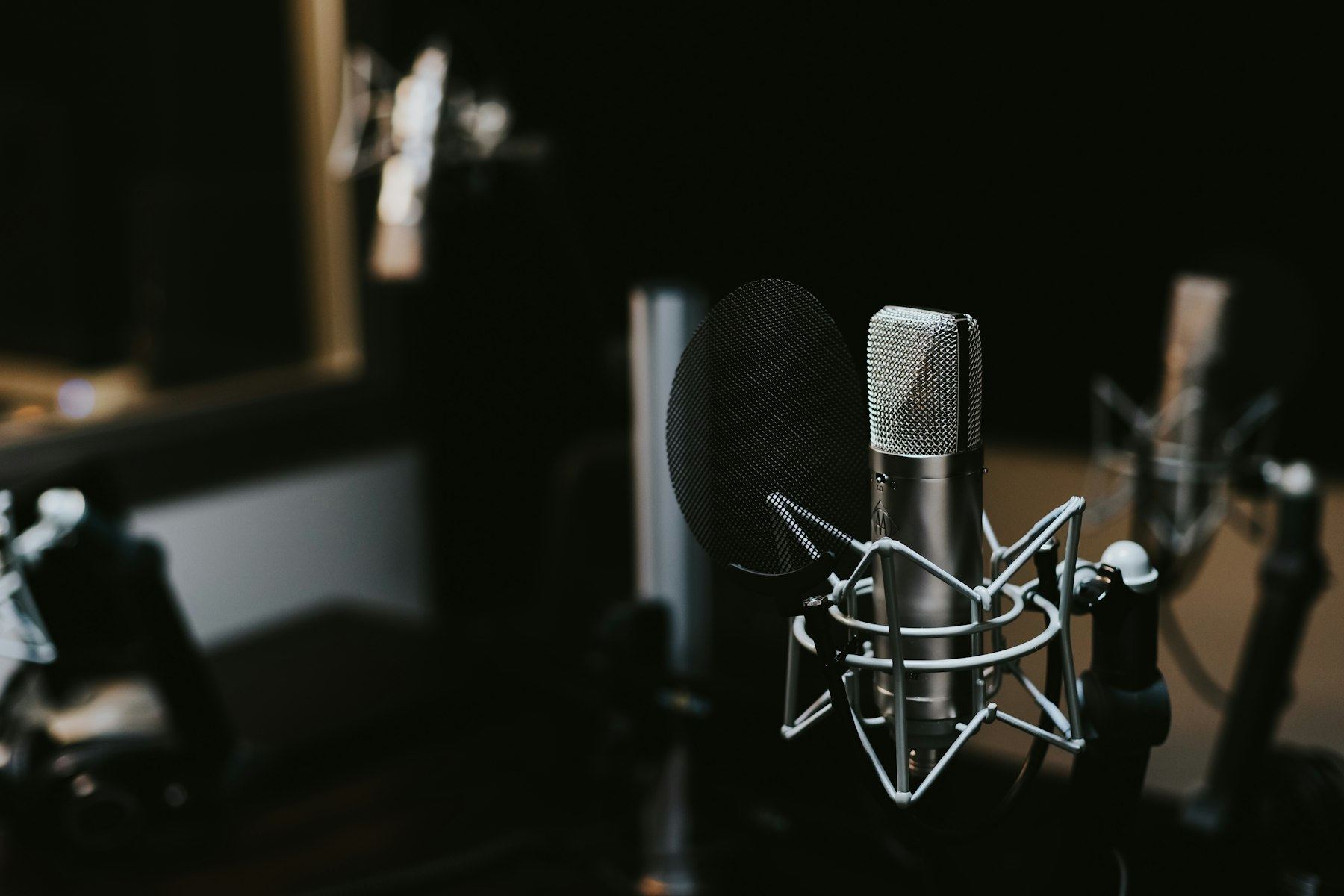 A condenser microphone in a dark recording room
