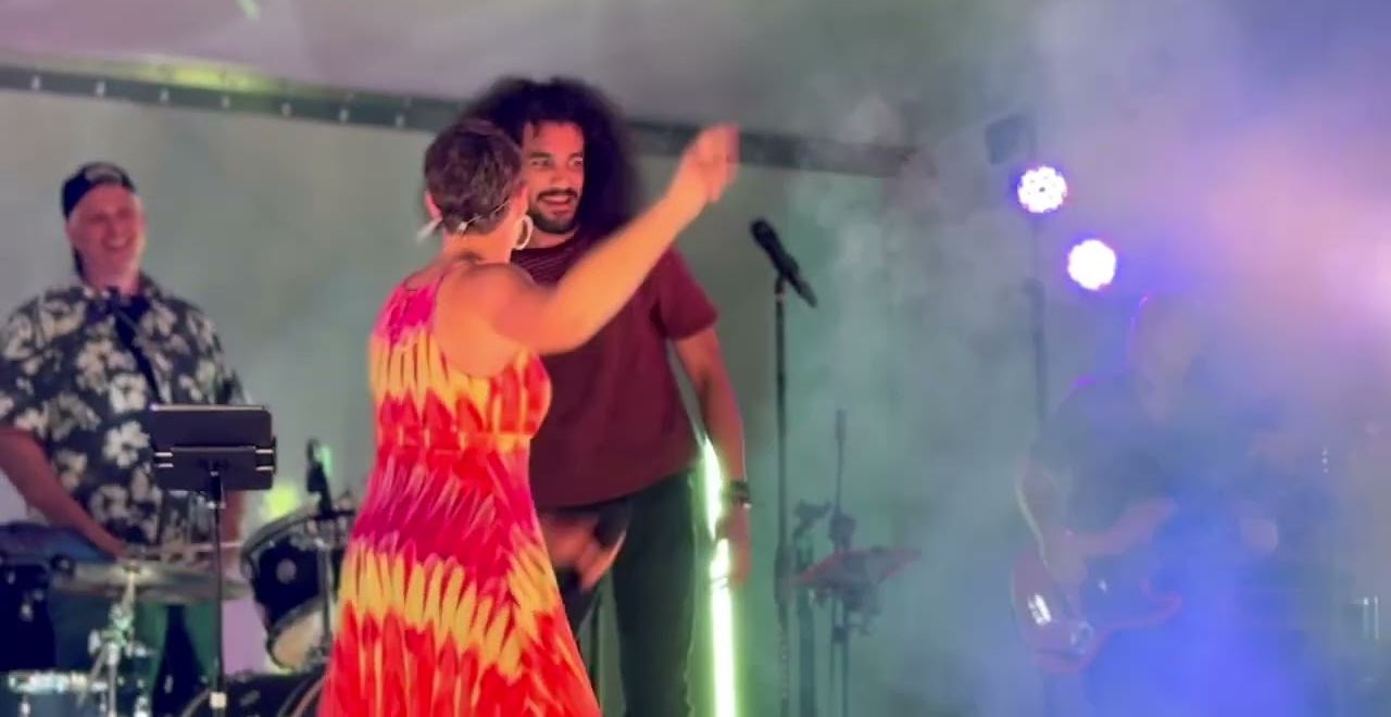 A band playing through stage haze